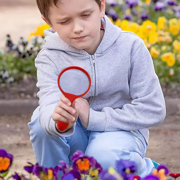 A kid using magnifying glass